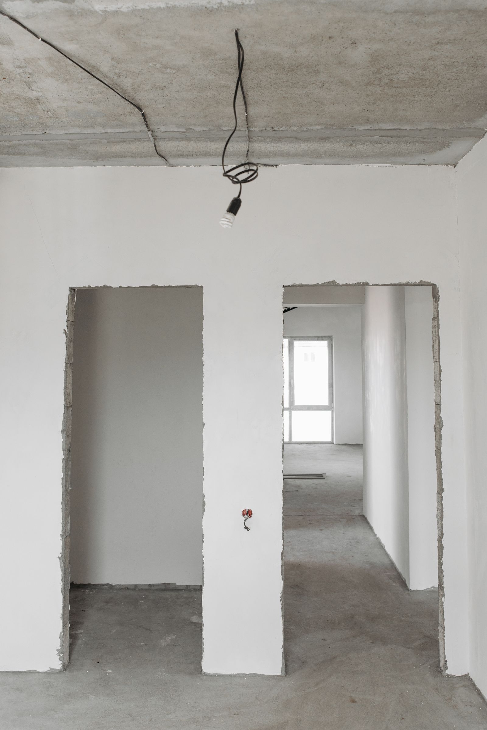 Freshly plastered walls and open doorways in a home mid-remodel